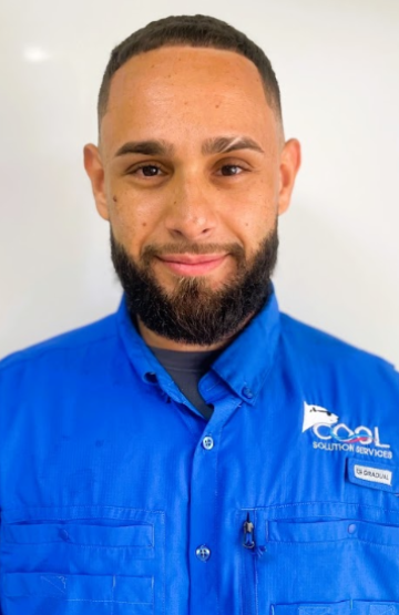 Man with short hair and beard wearing a blue work shirt